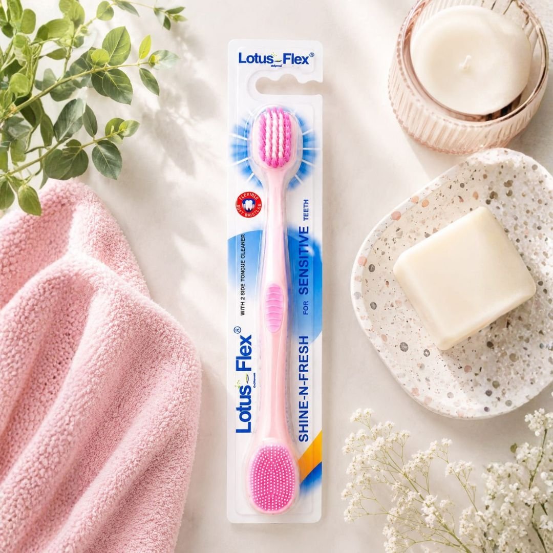 Lotus Flex Shine-N-Fresh pink toothbrush sensitive teeth soft bristles tongue cleaner lifestyle flat lay