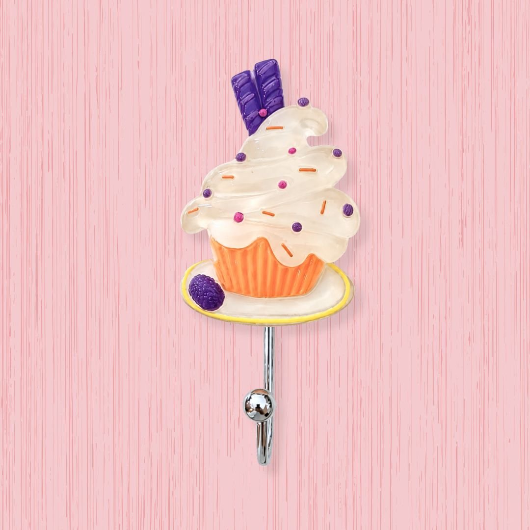 vanilla blueberry cupcake self-adhesive wall hook with pearl white swirl purple wafer mixed sprinkles and orange cup on white background