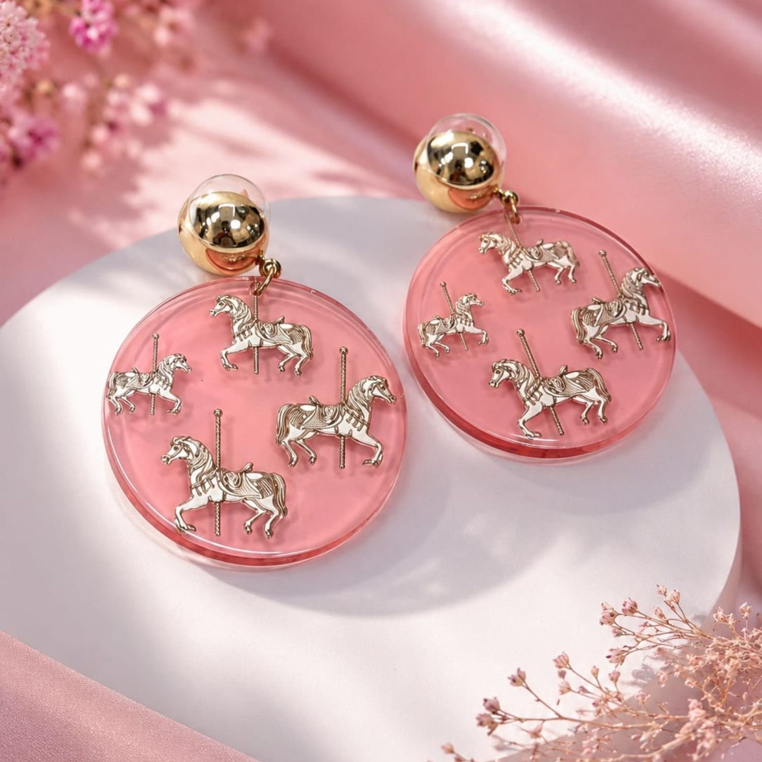 Carousel Dreams Earrings with transparent pink acrylic discs and gold-tone studs.