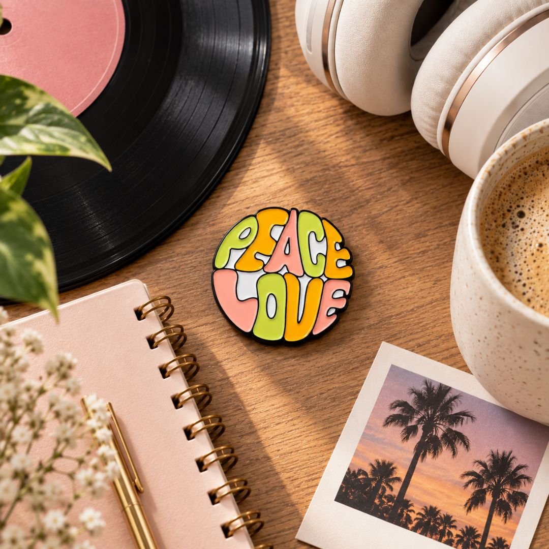 Peace Love colourful enamel pin held in hand